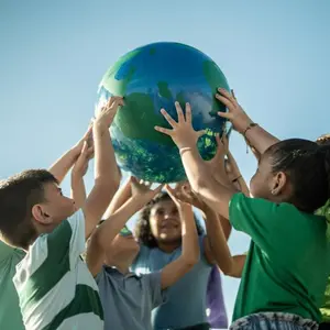 Children holding up globe