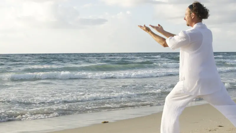 man tai chi on beach