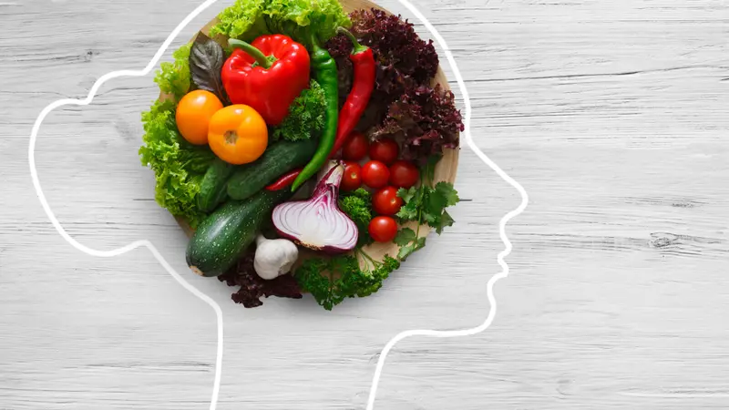 Fresh vegetables in woman head symbolizing health