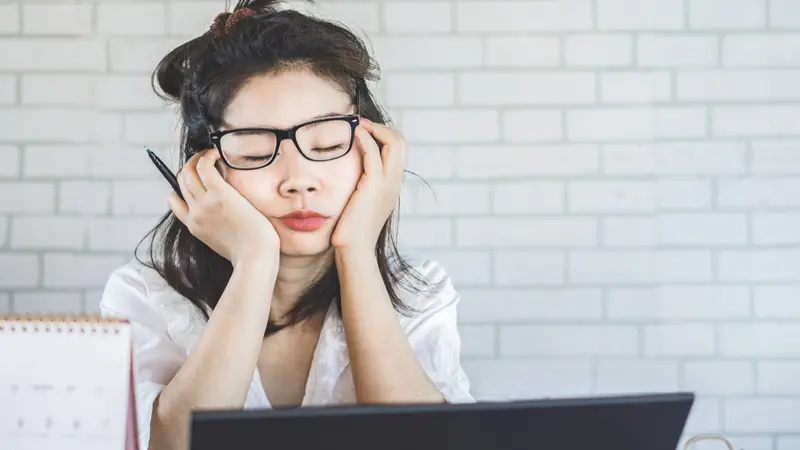 woman sleepy taking a nap at desk