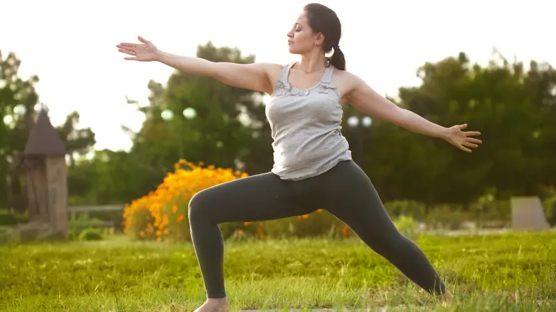 Young woman doing yoga exercise outdoors