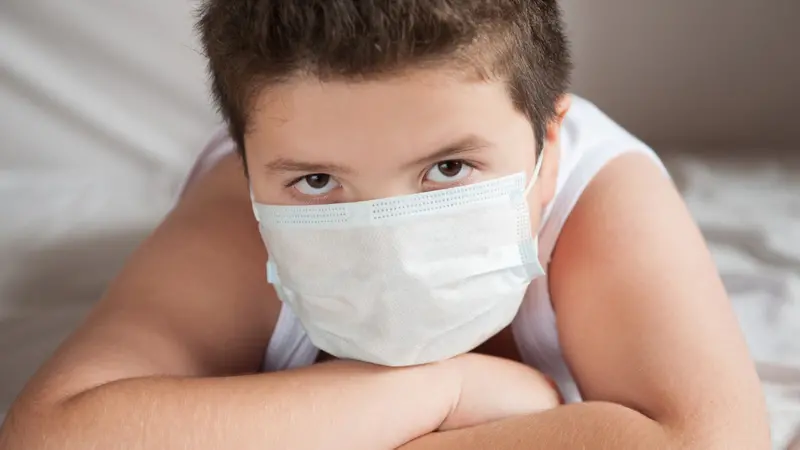 overweight boy wearing covid-19 mask