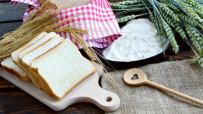 Green and Gold Wheat ears with wheat flour and White bread sliced. 