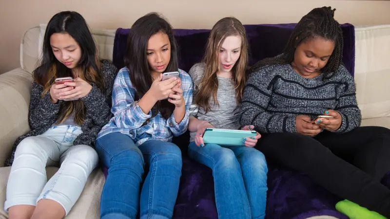 Group of kids on their mobile device