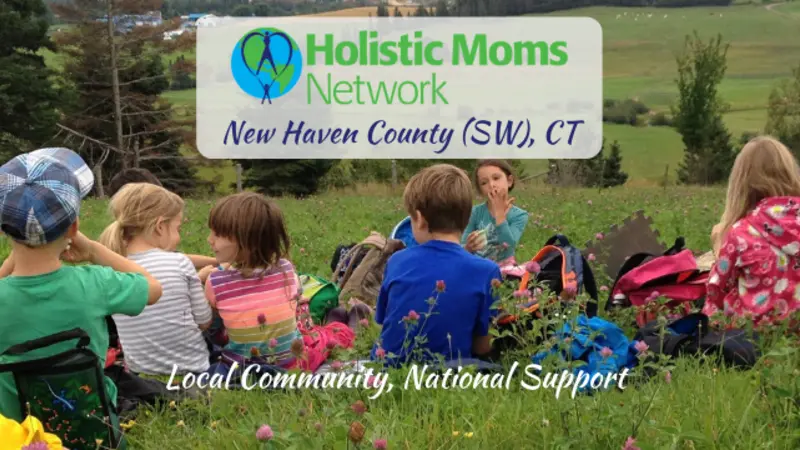 A group of children having a snack in a field, Holistic Moms Network New Haven CT chapter logo in a white box in top center.