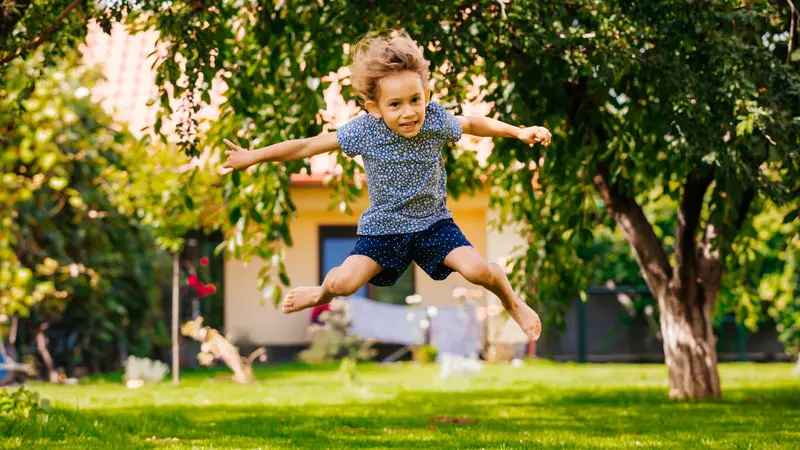 Active little girl has fun in the backyard