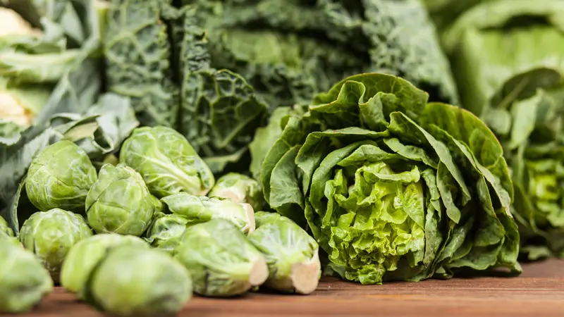 Assortment of green vegetables on wooden surface