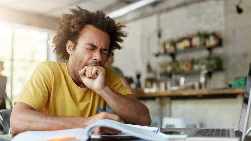 Exhausted sleepy black European man yawning