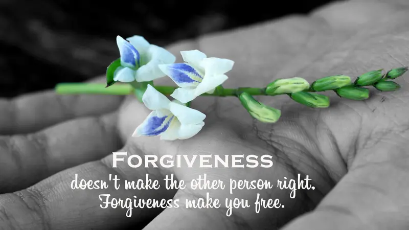 Inspirational quote - Forgiveness, does not make the other person right. Forgiveness make you free. With white flower plant in hand on black and white abstract art background.