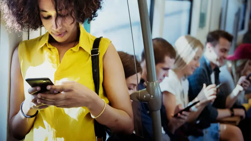 Young woman using a smartphone in a subway Young woman using a smartphone in a subway