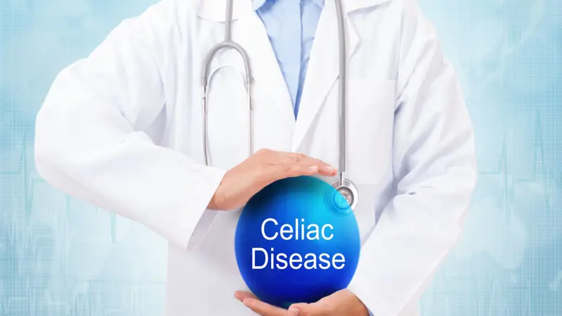 Doctor holding blue crystal ball with celiac disease sign on medical background.