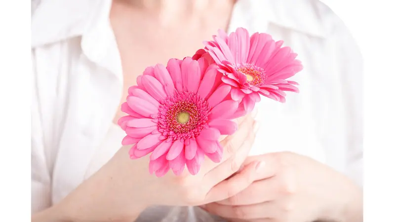 Woman holding pink flowers