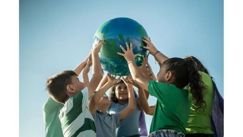 Children holding up globe