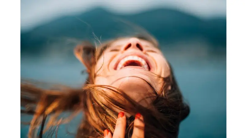 Woman with head back expressing joy