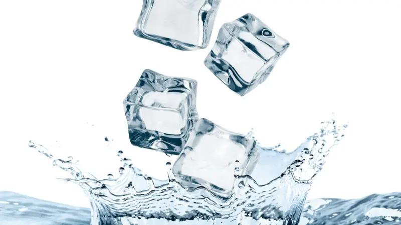 Ice cubes falling into water on white background