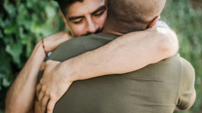 Two men hugging