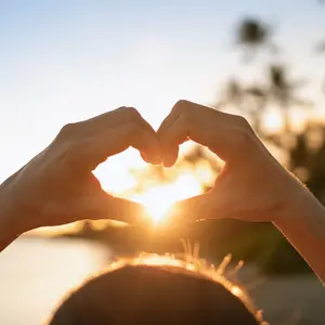 Hand shaped heart and rays of sunshine.