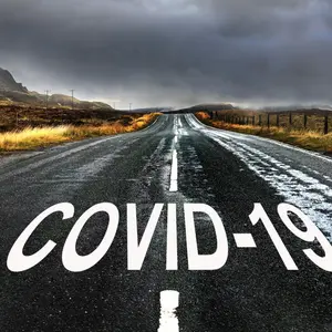 Road with diminishing perspective and text "COVID-19"