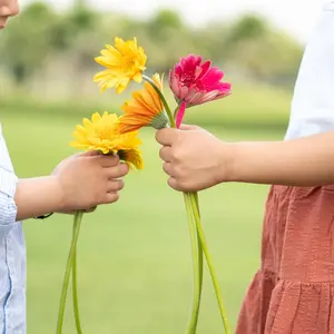 Two kids holding flowers