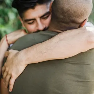 Two men hugging