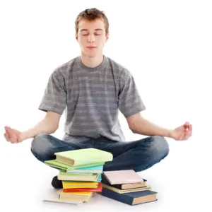 Teenager meditating with his books