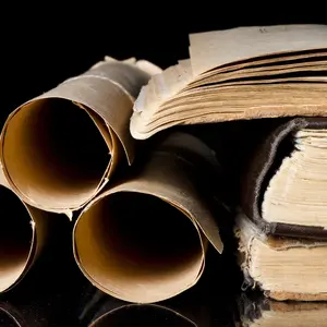 Many scrolls and old books on black background Many scrolls and old books on black background