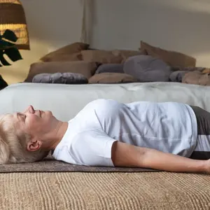 Senior caucasian woman practicing nidra yoga  Senior caucasian woman practicing nidra yoga