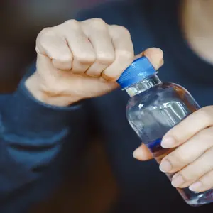 close-up hands uncapping plastic waterbottle  close-up hands uncapping plastic waterbottle