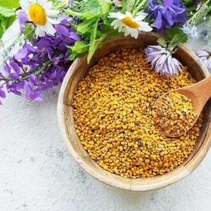 Bee pollen (not propolis) in a bowl with purple and white wildflowers Bee pollen (not propolis) in a bowl with purple and white wildflowers